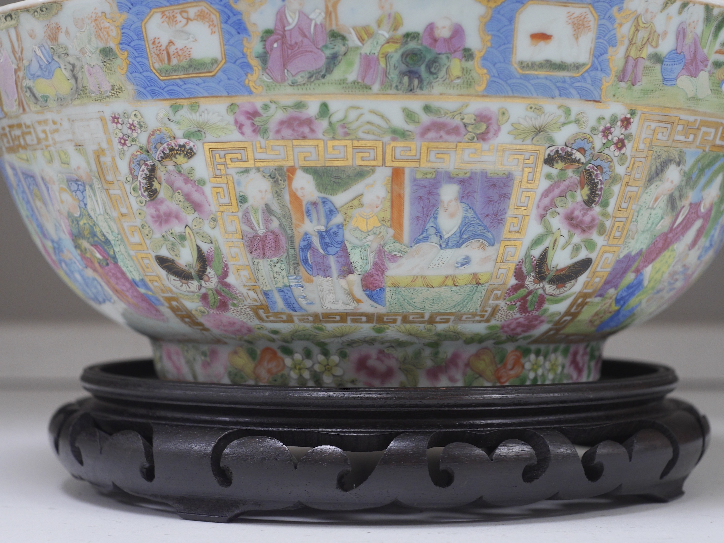 A 19th century Chinese famille rose bowl, on carved hardwood stand, 32cm diameter. Condition - chipped